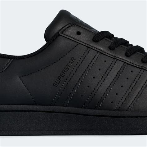 adidas superstar all black sneakers.